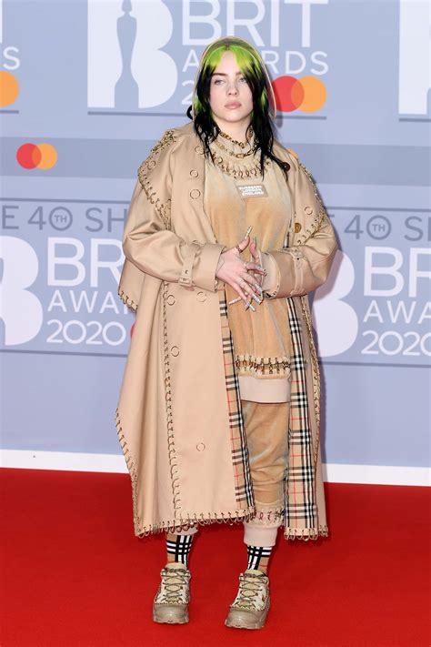 Billie Eilish soaks up the sun, June 2023. Eilish's friend Annabel Zimmer has shared a series of photos including one snap of the singer wearing black Versace sunglasses, silver chain necklaces ...
